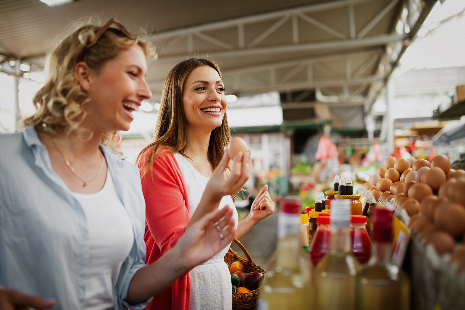 Happy woman buying fruits and vegetables at local food market